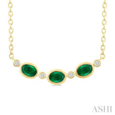 4X3MM Oval Cut Emerald and 1/50 Ctw Bezel Set Round Cut Diamond Precious Fashion Necklace in 10K Yellow Gold
