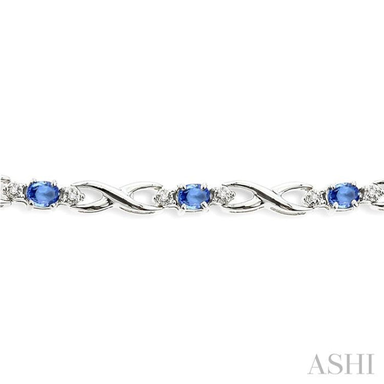 4x3mm Oval Cut Tanzanite and 1/10 Ctw Round Cut Diamond Bracelet in 10K White Gold
